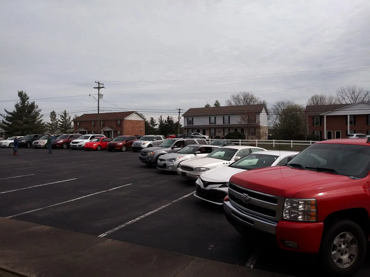 Cars lined up in the church parking lot for a Drive-in Service during the COVID-19 pandemic.
